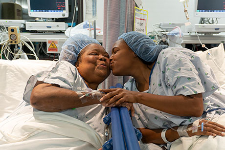 Olivia kissing her mother Monica on the cheek.